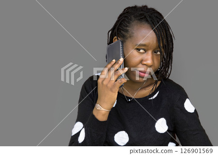 Isolated African Woman Talking on Smartphone Against Gray Background 126901569