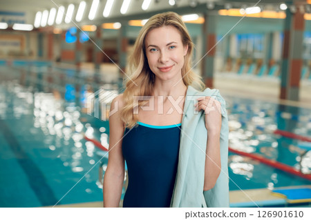 Pretty blonde woman with the towel in swimming pool 126901610