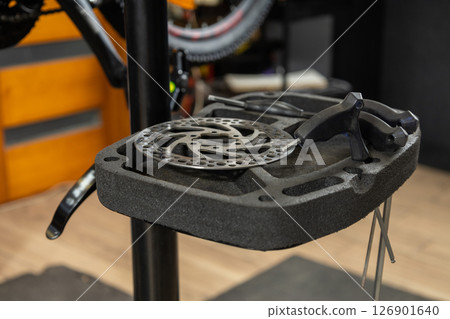 Close-up of bicycle wheel on repair stand in workshop 126901640