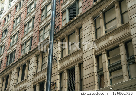 Close-up of a stone and brick building showing architectural details. The historic style reflects New York's urban heritage. Close-up of a stone and brick building showing architectural details. The historic style reflects New York's urban heritage. 126901736