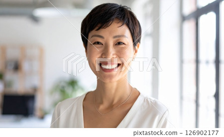 Smiling woman and a brightly lit office 126902177