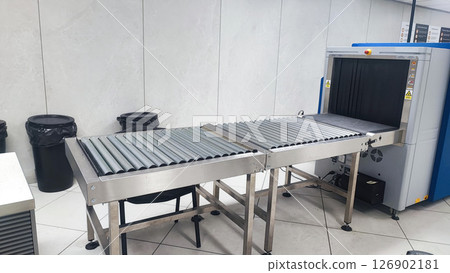 Security Checkpoint in Airport Terminal: Suitcases and Bags of Passengers Moving on Conveyor Belt Inside Advanced Metal Detector X-ray Scanner. Baggage Screening Procedure for Boarding Plane Flight. 126902181