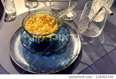 Breakfast table set with a bowl of cornflakes Breakfast table set with a bowl of cornflakes 126902246