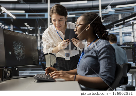 Data center technicians look at visualization on PC screen to pinpoint equipment performance issues. Server hub teamworking colleague look at data analysis graph to reduce hardware failures Data center technicians look at visualization on PC screen to pinpoint equipment performance issues. Server hub teamworking colleague look at data analysis graph to reduce hardware failures 126902851