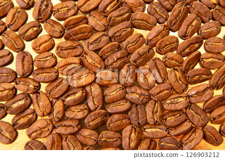 Stunning macro photography of roasted coffee beans on a shiny golden background 126903212