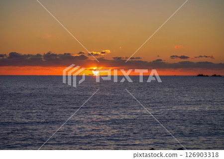 A fantastic scene of the Daruma sunrise rising over the Pacific Ocean A fantastic scene of the Daruma sunrise rising over the Pacific Ocean 126903318
