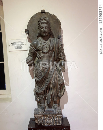 A standing Maitreya Buddha sculpture on display at the Peshawar Museum in Pakistan, the centre of Gandhara art 126903754