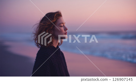 A woman surrounded by the sea and wind at dusk 126907145