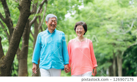 Smiling senior couple walking hand in hand 126907176