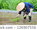 A rice terrace owner planting rice 126907556