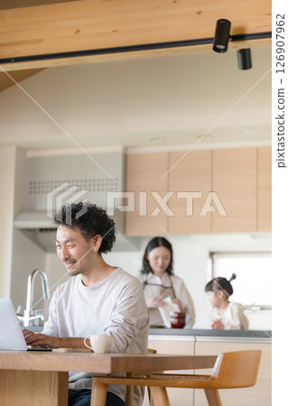 Men and families doing remote work at home 126907962