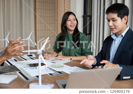 ESG Strategy Meeting. Professionals discussing renewable energy solutions with wind turbines. 126908176