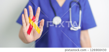 World hepatitis day awareness month, 28 July. Doctor holding Red and Yellow ribbon. Liver cancer, Jaundice, Cirrhosis, Failure, Enlarged, Hepatic Encephalopathy and Health concept 126908430