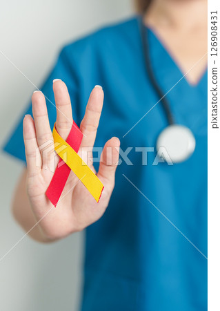World hepatitis day awareness month, 28 July. Doctor holding Red and Yellow ribbon. Liver cancer, Jaundice, Cirrhosis, Failure, Enlarged, Hepatic Encephalopathy and Health concept World hepatitis day awareness month, 28 July. Doctor holding Red and Yellow ribbon. Liver cancer, Jaundice, Cirrhosis, Failure, Enlarged, Hepatic Encephalopathy and Health concept 126908431