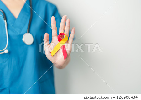 World hepatitis day awareness month, 28 July. Doctor holding Red and Yellow ribbon. Liver cancer, Jaundice, Cirrhosis, Failure, Enlarged, Hepatic Encephalopathy and Health concept 126908434