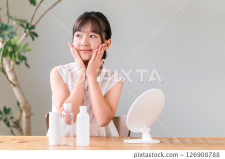 Acne care, skin care, children putting on makeup while looking in the mirror, girls, elementary school students, junior high school students Acne care, skin care, children putting on makeup while looking in the mirror, girls, elementary school students, junior high school students 126908788