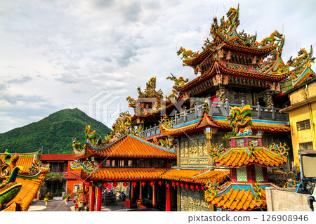 Richly decorated Shengming Temple in Juifen Ruifang District, New Taipei, Taiwan, features ornate dragon sculptures, intricate carvings, and vibrant red lanterns adorning its traditional tiled roof Richly decorated Shengming Temple in Juifen Ruifang District, New Taipei, Taiwan, features ornate dragon sculptures, intricate carvings, and vibrant red lanterns adorning its traditional tiled roof 126908946