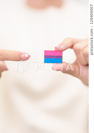Bisexuality Celebrate Day and LGBT pride month, LGBTQ or LGBTQIA concept. Hand holding purple, pink and blue flag shape for Lesbian, Gay, Bisexual, Transgender, Queer, Pansexual, Marriage Equality Law 126909007