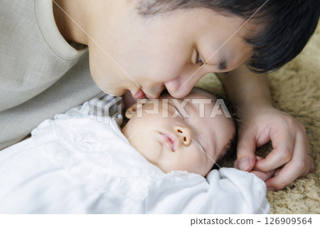 Baby taking a nap with dad 126909564