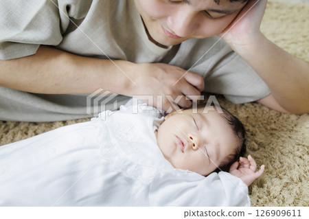 Baby taking a nap with dad 126909611