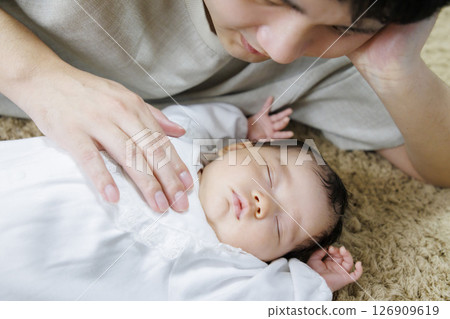 Baby taking a nap with dad 126909619