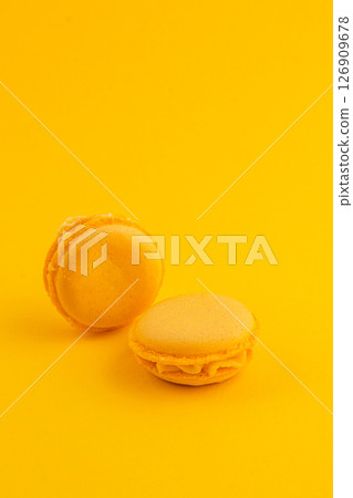 Yellow macarons on a bright yellow background in dessert setting Yellow macarons on a bright yellow background in dessert setting 126909678