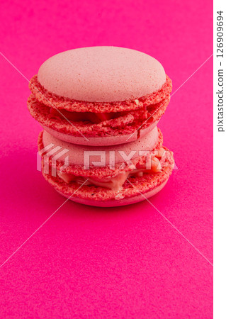 Colorful macarons stacked on pink background for dessert display Colorful macarons stacked on pink background for dessert display 126909694