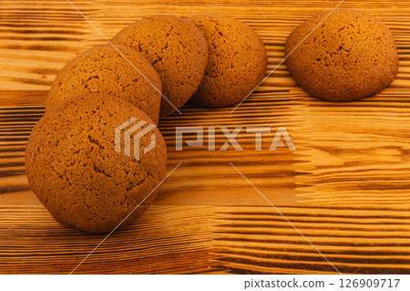 Delicious homemade brown cookies on wooden surface Delicious homemade brown cookies on wooden surface 126909717