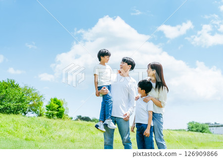 Family playing in the blue sky meadow 126909866
