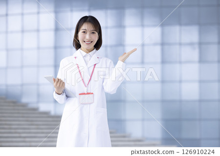 Portrait of a woman wearing a white coat 126910224