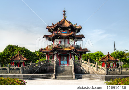 Cuiheng Pavilion, a multi-tier landmark in 228 Peace Memorial Park, Taipei, Taiwan, towers above broad stone staircases with red pillars, sweeping tiled roofs, and dragon-tipped eaves, all framed by 126910486