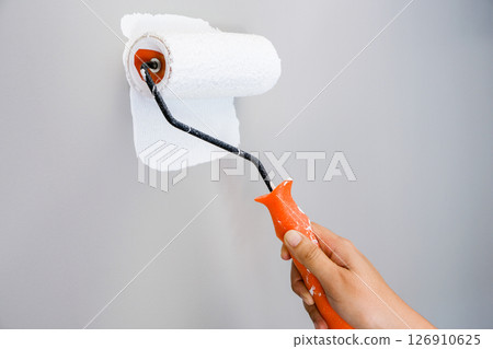 Home repairman paint the walls gray walls, painters use white paint brush rolls. Home repairman paint the walls gray walls, painters use white paint brush rolls. 126910625