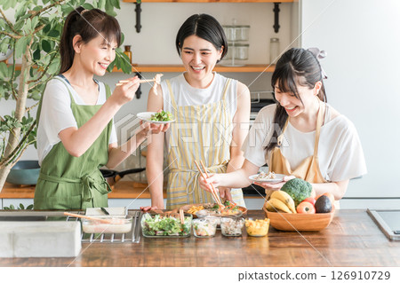 A female instructor and female students teaching cooking at a cooking class/cooking school A female instructor and female students teaching cooking at a cooking class/cooking school 126910729