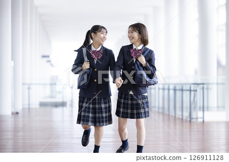 A high school girl walking happily down the hallway A high school girl walking happily down the hallway 126911128