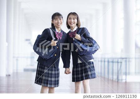 A high school girl walking happily down the hallway A high school girl walking happily down the hallway 126911130