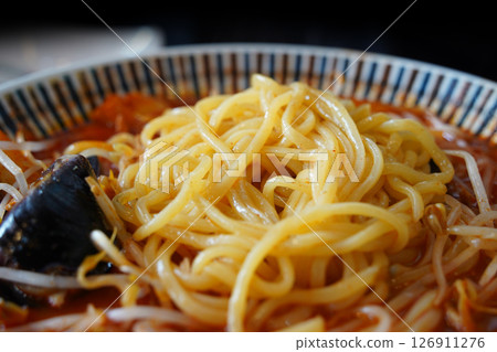 Close-up of Spicy Korean Jjambbong Noodles with Red Soup 126911276