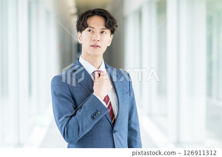 Businessman standing in the aisle. Businessman standing in the aisle. 126911312