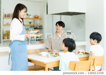 Family of four eating in the dining room Family of four eating in the dining room 126911339
