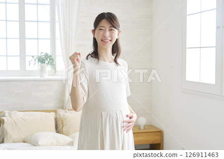 Pregnant woman, fist pump, home 126911463