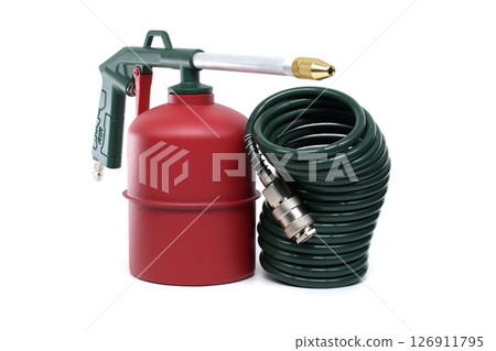 Green and Red Metal Tool with Coiled Hose on a White Background 126911795