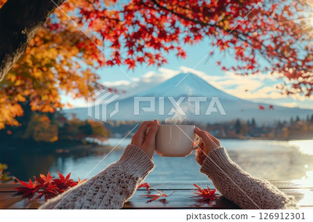 a woman with A cup of coffee on a table overlooking an autumn view. Generative AI. a woman with A cup of coffee on a table overlooking an autumn view. Generative AI. 126912301