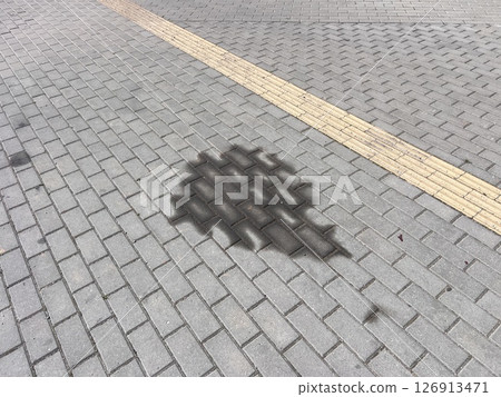 Leakage or leakage of oil from the car engine onto the paving slabs in a parking space, checking and maintaining the car in a car service center, engine breakdown. 126913471