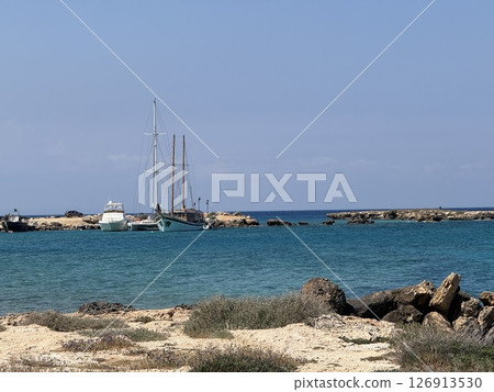 Picturesque beach, waves crashing on the sandy shore. Sea waves beat against the rocks. Cyprus Island, Mediterranean Sea. 126913530