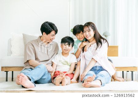 A family relaxing in the living room 126913562