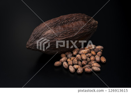 Cocoa pods and roasted cocoa beans on a black background 126913615