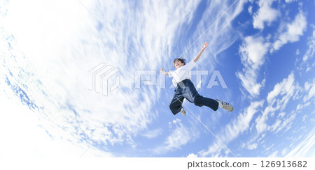 A man jumping into the blue sky A man jumping into the blue sky 126913682