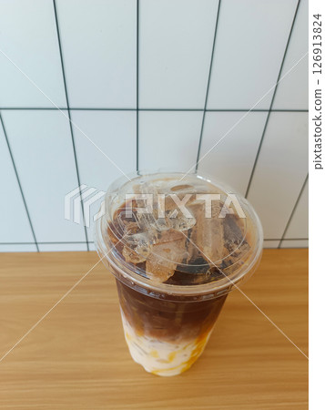 top view caramel coffee in a plastic cup, placed on a table, white tile wall background, drink, food, fashion, copy space top view caramel coffee in a plastic cup, placed on a table, white tile wall background, drink, food, fashion, copy space 126913824