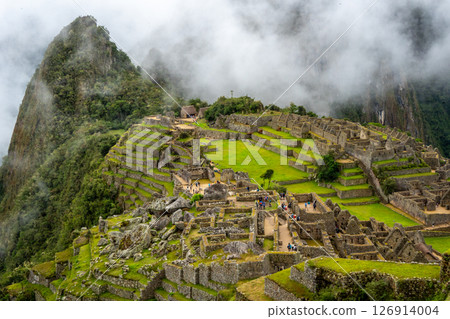 Panoramic view of Machu Picchu ruins surrounded by misty mountains, Peru 126914004