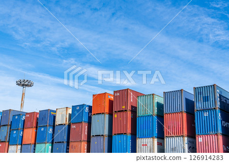 Shipping containers of various colors stacked in a container yard Shipping containers of various colors stacked in a container yard 126914283