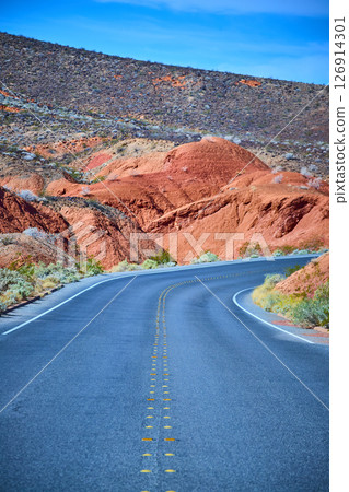Winding Desert Road with Red Rock Formations Eye-Level Perspective Winding Desert Road with Red Rock Formations Eye-Level Perspective 126914301